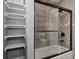 Stylish bathroom featuring a tiled shower with glass doors and built-in shelving at 1413 S East St, Indianapolis, IN 46225