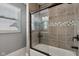 Nicely tiled bathtub shower with glass doors, window, and sleek hardware at 1413 S East St, Indianapolis, IN 46225