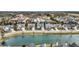 An aerial view capturing the neighborhood's layout with homes lining a pond and nearby commercial properties at 15745 Market Center Dr, Carmel, IN 46033
