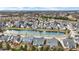An aerial view showcases a charming community with a serene pond and well-maintained homes at 15745 Market Center Dr, Carmel, IN 46033
