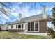 Back of the home with patio, lawn, and screened-in porch at 15745 Market Center Dr, Carmel, IN 46033