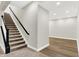 Finished basement with carpeted stairs and light hardwood-style floors, perfect for entertaining at 15745 Market Center Dr, Carmel, IN 46033