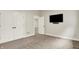Bedroom including carpeted floors, closet doors, and a wall-mounted TV for convenience at 15745 Market Center Dr, Carmel, IN 46033