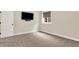 Neutral bedroom featuring carpet, a window, and a mounted television for relaxation at 15745 Market Center Dr, Carmel, IN 46033