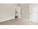 A bedroom with an open doorway and neutral-colored carpet at 15745 Market Center Dr, Carmel, IN 46033