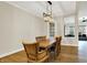 Dining area shows wooden table, chairs, wood floor, modern lighting, and neutral wall color at 15745 Market Center Dr, Carmel, IN 46033