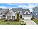 Charming two-story home with landscaped front yard and attached two car garage at 15745 Market Center Dr, Carmel, IN 46033