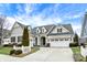 Attractive two-story house with a well-manicured lawn and a two-car garage at 15745 Market Center Dr, Carmel, IN 46033