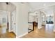 Open-concept hallway with hardwood floors connecting to dining and living area at 15745 Market Center Dr, Carmel, IN 46033