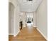 Open-concept hallway with hardwood floors connecting to dining and living area at 15745 Market Center Dr, Carmel, IN 46033