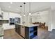 Modern kitchen with island, stainless appliances, and eat-in area with dining table set at 15745 Market Center Dr, Carmel, IN 46033