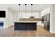 Modern kitchen featuring a large island, white cabinets, and stainless steel appliances at 15745 Market Center Dr, Carmel, IN 46033