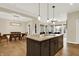 Open kitchen featuring a large island with granite countertops, sink, and seating at 15745 Market Center Dr, Carmel, IN 46033