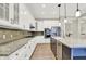 Gourmet kitchen with white cabinets, granite countertops, stainless steel appliances, and backsplash at 15745 Market Center Dr, Carmel, IN 46033