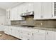 Stylish kitchen featuring white cabinets, granite countertops and backsplash, and modern appliances at 15745 Market Center Dr, Carmel, IN 46033
