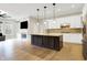 Modern kitchen with a large island, white cabinets, and stainless steel appliances at 15745 Market Center Dr, Carmel, IN 46033