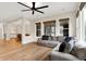 Spacious living room with a large couch, hardwood floors, and open access to the dining area at 15745 Market Center Dr, Carmel, IN 46033