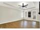 Spacious primary bedroom with wood floors, ceiling fan, tray ceiling and abundant natural light at 15745 Market Center Dr, Carmel, IN 46033
