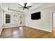 Main bedroom features wood floors, tray ceiling, ceiling fan and a TV on the wall at 15745 Market Center Dr, Carmel, IN 46033
