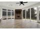 Bright sunroom with fireplace, ceiling fan, and large windows offering plentiful natural light at 15745 Market Center Dr, Carmel, IN 46033