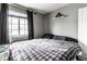 Comfortable bedroom with modern design, a plush plaid bed, and lots of sunlight at 163 Country Wood Dr, Whiteland, IN 46184