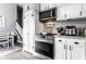 Well-lit kitchen featuring stainless steel appliances, white cabinets, and modern countertops at 163 Country Wood Dr, Whiteland, IN 46184