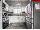 Spacious kitchen with stainless steel appliances, white cabinets, and a bright window view at 163 Country Wood Dr, Whiteland, IN 46184