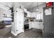 Well-lit kitchen featuring stainless appliances, white cabinets, pantry, and gray vinyl flooring at 163 Country Wood Dr, Whiteland, IN 46184