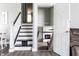 Open staircase view, showing living room with fireplace and gray and white decor at 163 Country Wood Dr, Whiteland, IN 46184