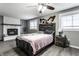 Cozy bedroom featuring modern decor, a fireplace, and neutral colors at 163 Country Wood Dr, Whiteland, IN 46184