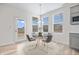 Cozy dining area with a round table, modern light fixture, and access to the outdoor patio at 16401 Brigham Ln, Westfield, IN 46074