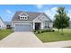 Charming single Gathering home with a well-maintained lawn and a two-car garage at 16401 Brigham Ln, Westfield, IN 46074