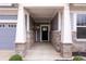 Covered front porch with stone accents and a black front door at 16401 Brigham Ln, Westfield, IN 46074