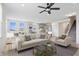 Open-concept living room with staircase and kitchen views, showcasing a modern design at 16401 Brigham Ln, Westfield, IN 46074