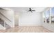 Bright living room featuring an adjacent staircase and luxury vinyl plank flooring at 16401 Brigham Ln, Westfield, IN 46074