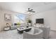 Comfortable living room with a ceiling fan, neutral decor, and a stylish entertainment center at 16401 Brigham Ln, Westfield, IN 46074