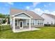 Covered outdoor patio with brick accents and a ceiling fan overlooking the lawn at 16401 Brigham Ln, Westfield, IN 46074
