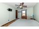 Light-filled bedroom with wood floors, a ceiling fan, and views of the surrounding landscape at 22569 State Road 37 N, Noblesville, IN 46060