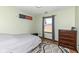 Comfortable bedroom features light green walls, wood floors, and an American flag decoration at 22569 State Road 37 N, Noblesville, IN 46060