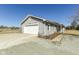 Home with a large garage, long driveway, and ample parking, all set against a backdrop of trees and clear skies at 22569 State Road 37 N, Noblesville, IN 46060