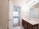 Modern bathroom with wood vanity, a tub-shower combo, and view into a bright, airy loft space at 2332 Brightwell Pl, Indianapolis, IN 46260