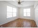 Bright bedroom with hardwood floors, ceiling fan, and windows for ample natural light at 2332 Brightwell Pl, Indianapolis, IN 46260