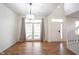 Open dining area with chandelier, wood floors, and patio access at 2332 Brightwell Pl, Indianapolis, IN 46260