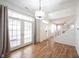Bright entryway featuring wood floors, a modern light fixture and glass paneled french doors at 2332 Brightwell Pl, Indianapolis, IN 46260