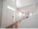 Bright foyer with wood floors, white staircase, and natural light at 2332 Brightwell Pl, Indianapolis, IN 46260