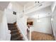 Open foyer with staircase, wood flooring, and stylish lighting at 2332 Brightwell Pl, Indianapolis, IN 46260