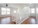 Bright hallway with wood floors featuring staircase access, perfect as a transition space at 2332 Brightwell Pl, Indianapolis, IN 46260