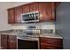 Close up of the oven, range, and microwave in the kitchen with granite countertops at 2332 Brightwell Pl, Indianapolis, IN 46260