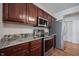 Kitchen featuring stainless steel appliances, wood cabinets, and granite countertops at 2332 Brightwell Pl, Indianapolis, IN 46260