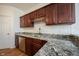 Kitchen sink area with stainless steel appliances, wood cabinets, and granite countertops at 2332 Brightwell Pl, Indianapolis, IN 46260
